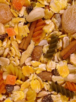 A close up of a bowl of Mom's Nutty Noodle 1 lb. with nuts and fruit.