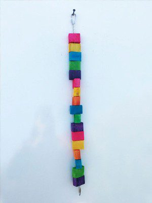 A colorful Rolls & Puzzle wooden bird toy hanging from a hook.