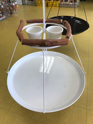 Two Omar's Large Hanging Stands hanging on a shelf in a store.