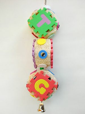 A colorful Luffa Foam toy with a bell hanging from it.