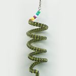 A green spiral Millet Holder hanging from a hook.