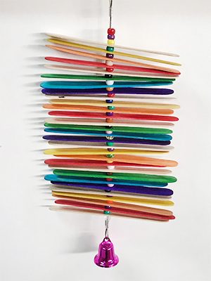 A Tongue Sticks and Beads hanger with a bell hanging from it.