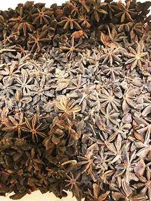 A pile of dried Star Anise 1 lb. on a table.