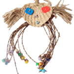 A Funny Face woven basket with colorful beads on it.